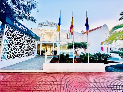 a building with flags in front of it at Luxury villa Fanabe with private garden in Adeje