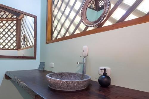a bathroom with a stone sink on a counter at Casa Auratus Manzaillo wild life in Manzanillo