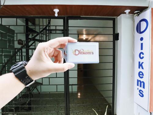 a person taking a picture of a door with a danger sign at Dickem's Transient House in Cebu City