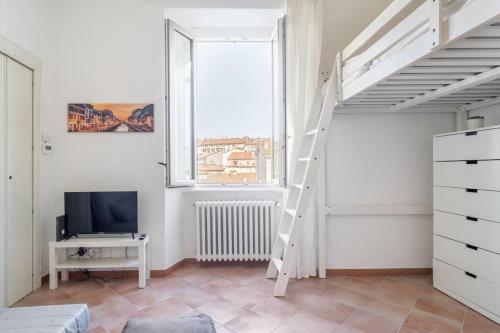 a bedroom with a loft bed and a tv at Relax sui Navigli in Milan