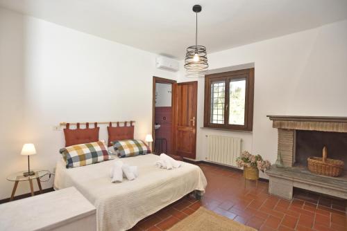 a bedroom with two beds and a fireplace at Casale del Passatore sas in Rocchette