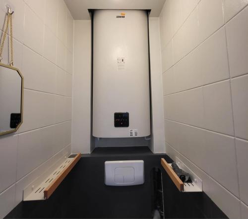 a small bathroom with a toilet in a stall at GILMORE Home - close to PARIS center in La Courneuve
