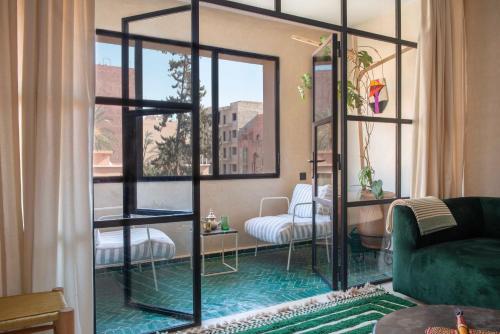a living room with a room with a glass door at Appartements Brummell Marrakech in Marrakech