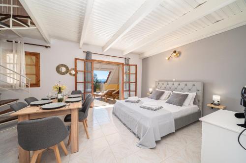 a bedroom with a bed and a table and chairs at Southbank seafront apartments in Katelios