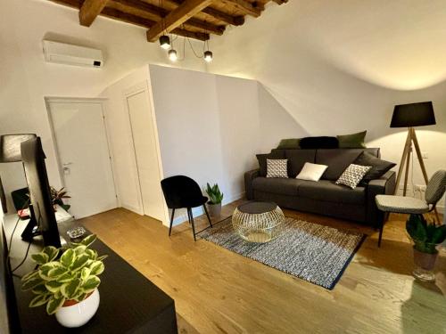 a living room with a couch and a table at Olivuzza 27 in Palermo