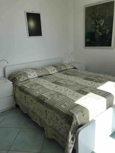 a bedroom with a bed with a blanket on it at La Palma “Villa Nunzia” in Serrara Fontana