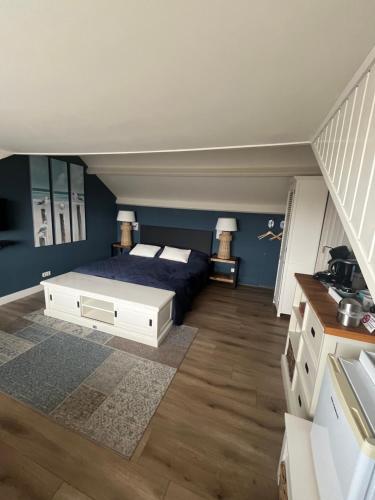 a bedroom with a bed and blue walls at B&B De Koog Texel in De Koog