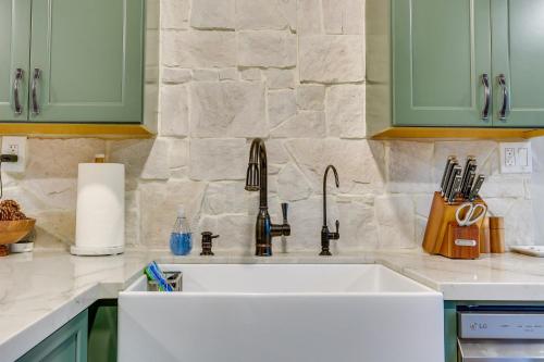 a kitchen with a white sink and green cabinets at Cozy Wrightwood Cabin Family and Pet Friendly! in Wrightwood