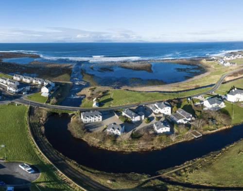 an aerial view of a village next to the ocean at Fishermans Cottage Stunning Two Bedroom with Views close to town in Bundoran