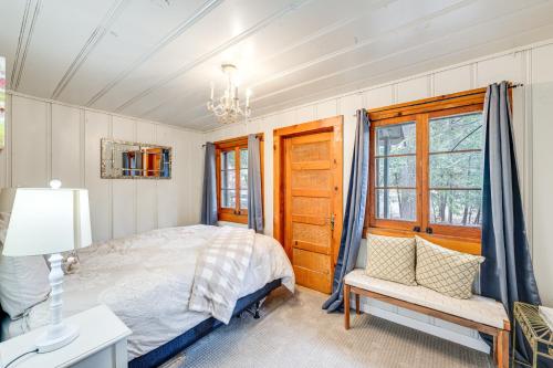a bedroom with a bed and a desk and a window at Serene Bass Lake Cabin Near Shopping and Dining! in Bass Lake