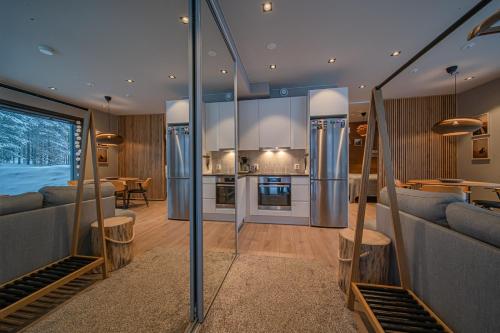 a living room with a kitchen and a dining room at Levi Platinum Aurora in Levi