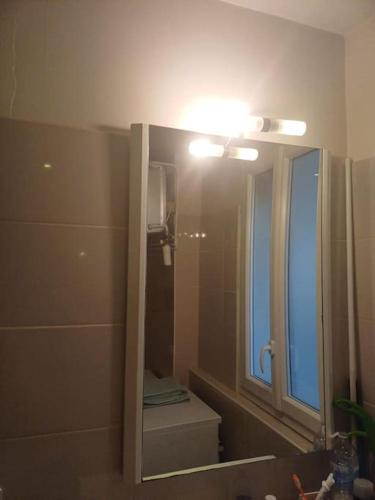 a bathroom with a mirror and a toilet and a sink at Au cœur du 5ème de Paris in Paris