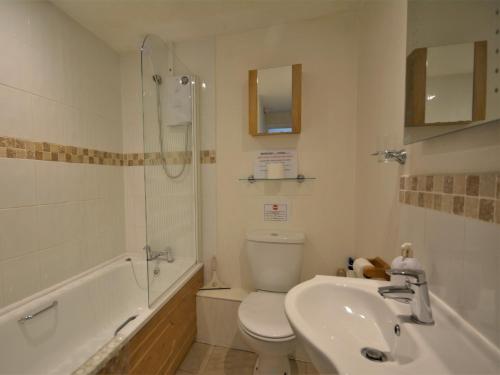 a bathroom with a toilet and a sink and a shower at 2 Bed in Padstow KCOTT in Wadebridge