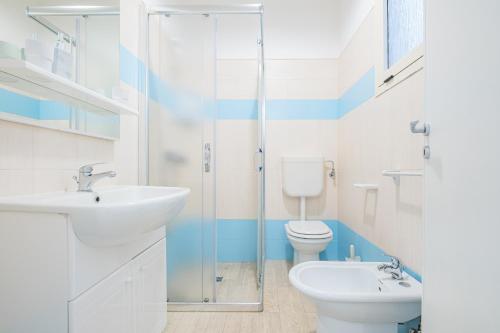 a bathroom with a toilet and a sink and a shower at Villa Monteduro - Leuca in Leuca