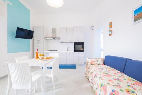a living room with a white table and a couch at Villa Monteduro - Leuca in Leuca