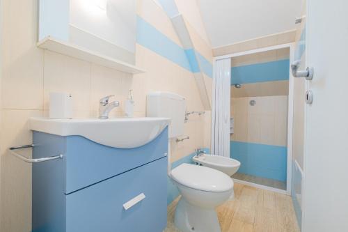 a bathroom with a white toilet and a sink at Villa Monteduro - Leuca in Leuca