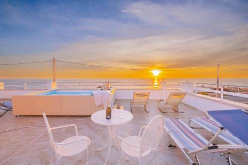 a balcony with chairs and a table and a hot tub at Villa Monteduro - Leuca in Leuca