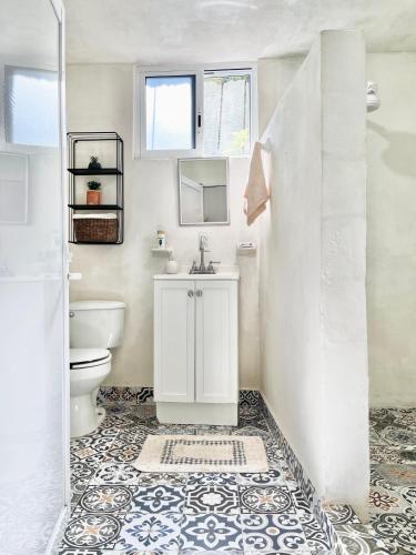 a bathroom with a toilet and a sink at Casa Estrella Azul in San José del Cabo