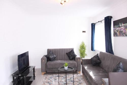 a living room with a couch and a table at Stunning 3 bedrooms Entire flat in Harlow, Essex in Harlow