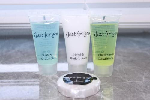 three bottles of just for you hand and body lotion at Stunning 3 bedroom apartment in Harlow, Essex in Harlow