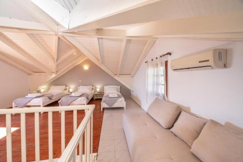 a living room with white furniture and a balcony at Southbank seafront apartments in Katelios