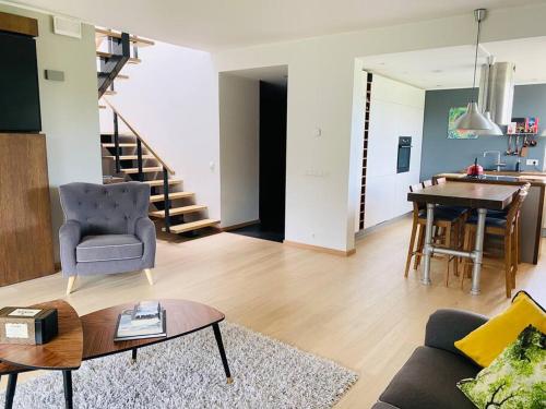 a living room with a couch and a table at A Cozy Retreat - Sauna & Garden - 3BDR in Pärnamäe