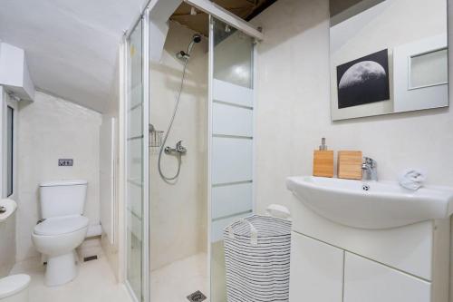a white bathroom with a sink and a toilet at Cosy Nest in Athens 4' to Metro Station Petralona in Athens
