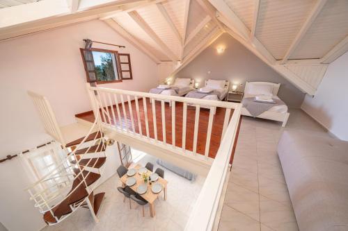 an overhead view of a living room with a staircase at Southbank seafront apartments in Katelios