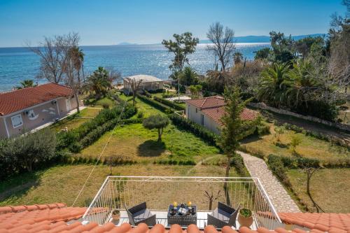 an aerial view of a house with the ocean in the background at Southbank seafront apartments in Katelios