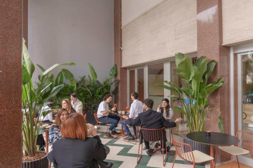 Un groupe de personnes assises autour d'une table dans un bâtiment dans l'établissement Moderno Hotel Roma, à Rome