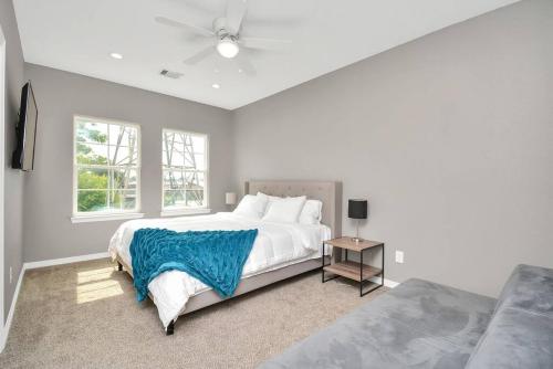 a white bedroom with a large bed and a window at Rodeo Ready!!!! Modern 3 bedroom home in Houston
