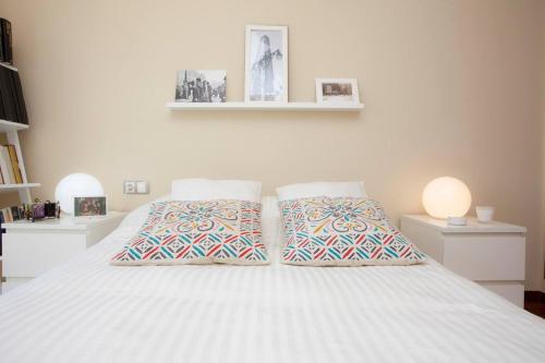a bedroom with a white bed with two pillows at One bedroom apartement with wifi at Mislata in Valencia