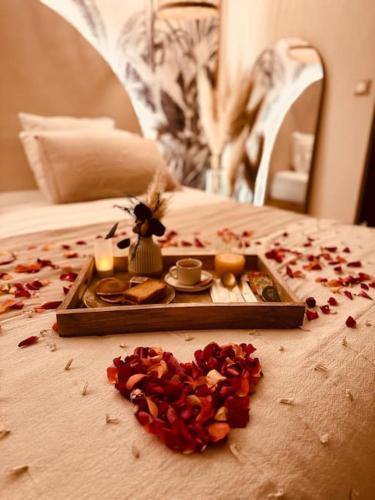 een dienblad met eten en kaarsen op een bed bij LoveRoom, La suite de l’extase in Puget-sur Argens