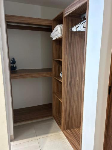 a walk in closet with wood paneling at Vista al mar, Alberca, Netflix, Playa - Facturamos in Conchal