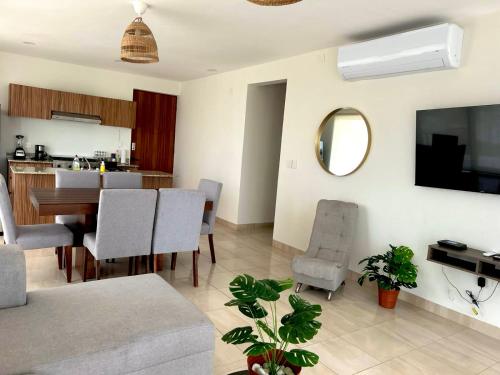 a living room with a table and a dining room at Vista al mar, Alberca, Netflix, Playa - Facturamos in Conchal