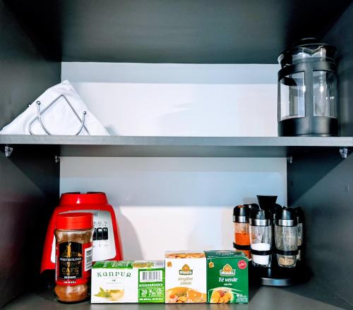 a refrigerator with some food items on a shelf at Loft between best business centers & restobars in Bogotá