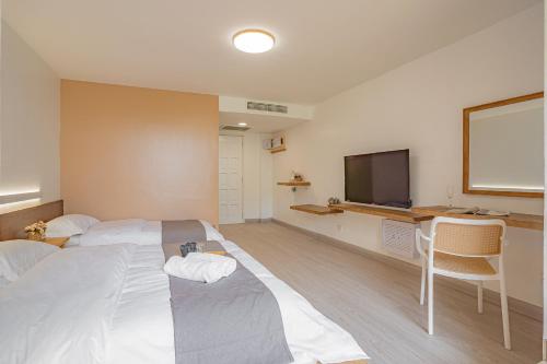 a hotel room with two beds and a flat screen tv at BIDONG VIEW RESORT in Kuala Terengganu