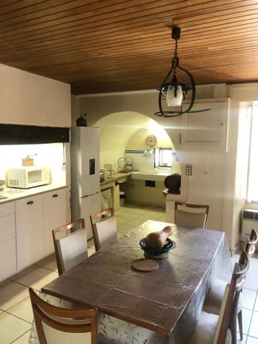 une cuisine et une salle à manger avec une table et des chaises dans l'établissement Le pigeonnier maison de caractère logement 4 personnes La maisonnette rénovée logement 2 personnes, à Floirac