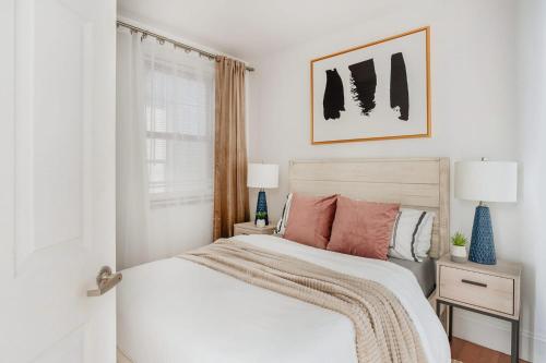 a white bedroom with a bed and a window at 69-4D Trendy Lower East Side 1B BRAND NEW in New York