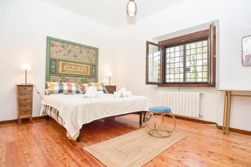 a bedroom with a bed and a blue stool at Casale del Passatore sas in Rocchette