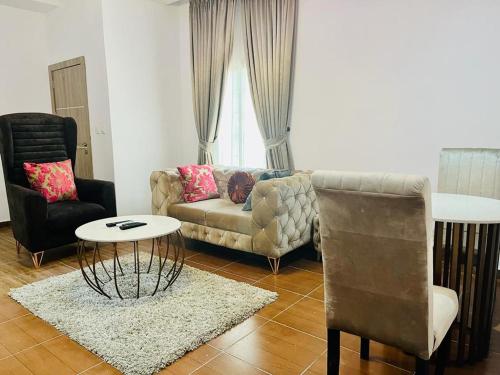 a living room with a couch and a table at Diaggello Homex Apartment in Lekki