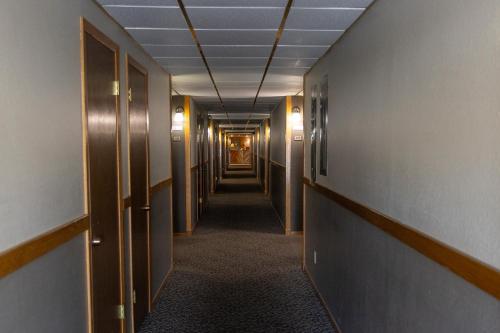 a hallway of an office building with a long corridor at Rocker Inn in Butte