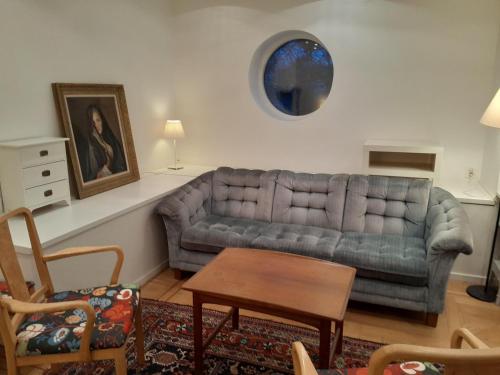 a living room with a couch and a table at Floravägen 11 in Lidingö