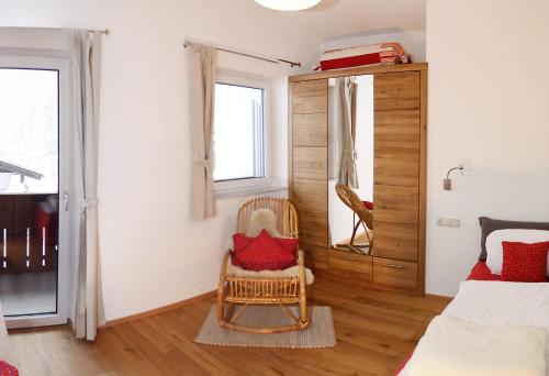 a bedroom with a bed and a chair at Appartement De Luxe - 140m² in Elbigenalp