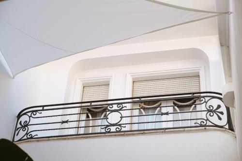 a balcony of a white building with a window at ALBERGO DIFFUSO ROSSI DIMORA Di CHARME in Turi