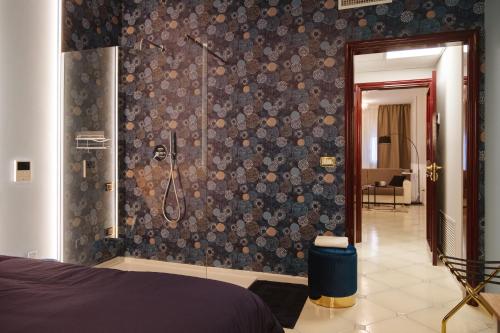 a bathroom with a shower and a bedroom at ALBERGO DIFFUSO Dimora Rossi Charme B&B in Turi