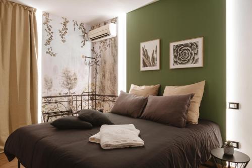 a bed in a room with a green wall at ALBERGO DIFFUSO Dimora Rossi Charme B&B in Turi