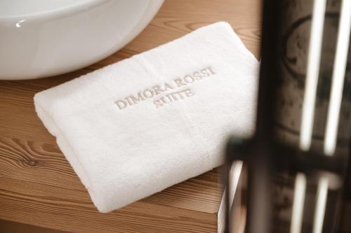 a white napkin on a table next to a plate at ALBERGO DIFFUSO Dimora Rossi Charme B&B in Turi