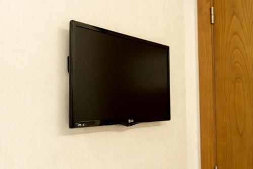 a flat screen tv hanging on a wall at Quinta Do Passal in Paços de Ferreira