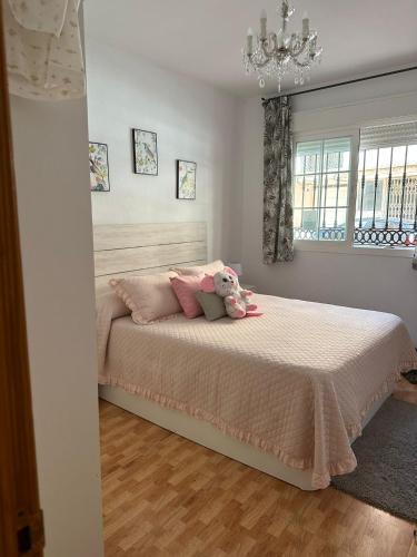 a bedroom with a bed with a teddy bear on it at Apartamento Brisa junto al mar in Roquetas de Mar